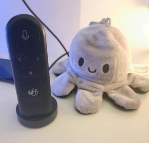 A photo of the Microsoft Teams Presenter+ device sitting next to a reversable Octopus showing its happy face.